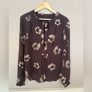 Beautiful Ann Taylor flowered blouse with ties in the front.